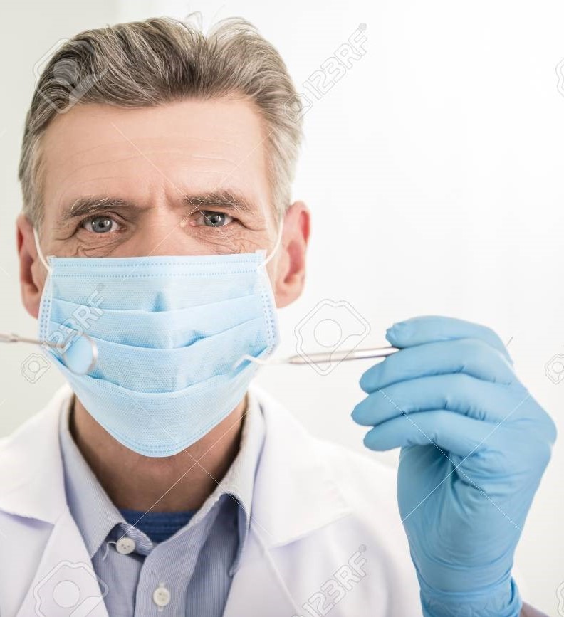 Dentists wearing masks and gloves at Sharan Dental Clinic